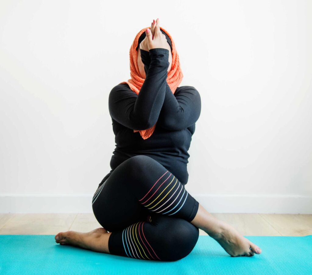 cow pose and mushlim women practicing yoga