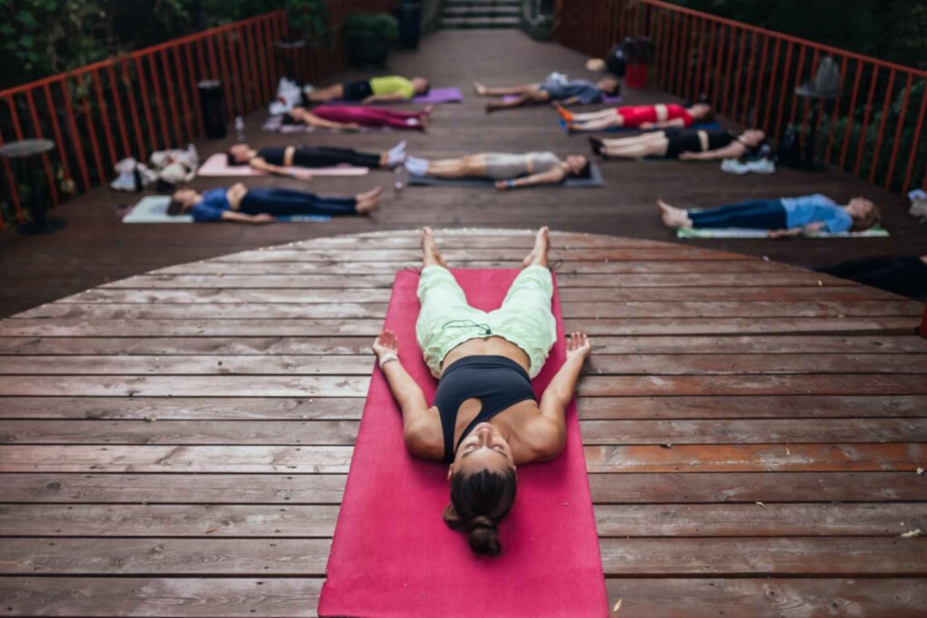 corpse pose shavasana yoga studio students along with